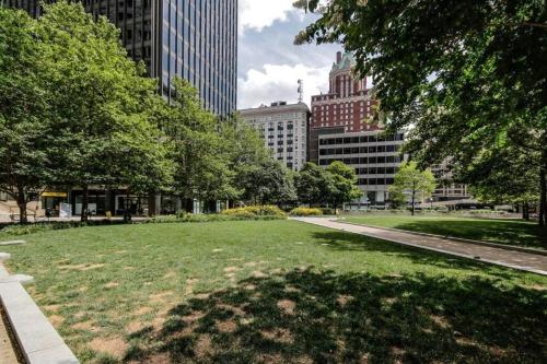 a park in a city with tall buildings at Harbor apartments Free indoor Parking in Baltimore