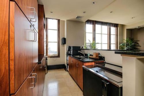 a kitchen with wooden cabinets and a counter top at Harbor apartments Free indoor Parking in Baltimore