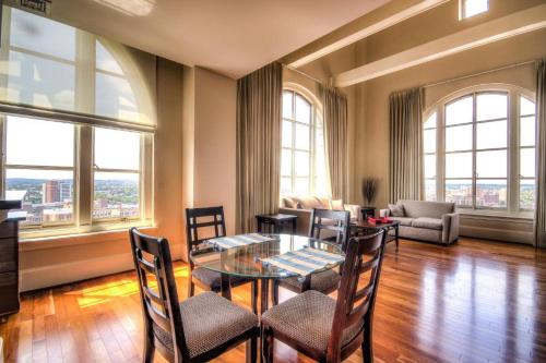 a living room with a glass table and chairs at Harbor apartments Free indoor Parking in Baltimore