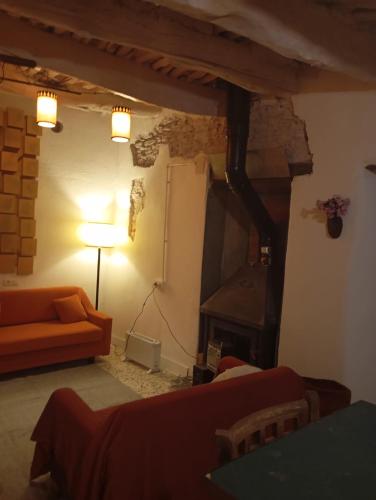 a living room with a couch and a fireplace at Casa Lola in Busquístar