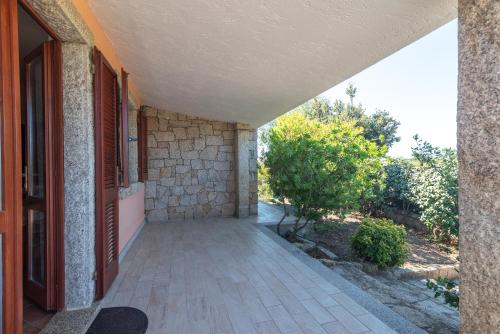 a hallway of a building with a door and a tree at Marelò in Vignola Mare