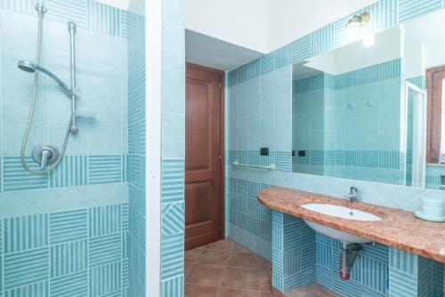 a bathroom with a sink and a shower at Marelò in Vignola Mare
