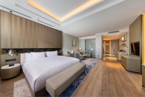 a bedroom with a large bed and a living room at Braira Hafar Al-Batin in Hafr Al Baten