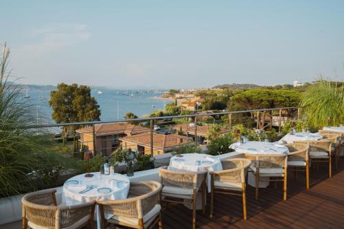 a row of tables and chairs on a balcony at Kube Saint-Tropez in Saint-Tropez