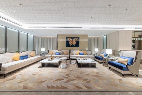 a living room with couches and chairs and tables at Braira Hafar Al-Batin in Hafr Al Baten