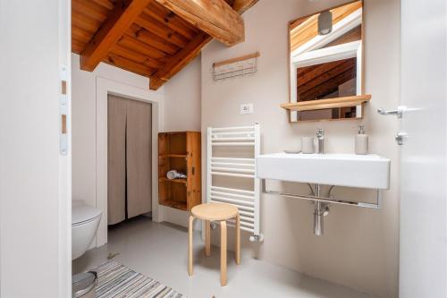 a bathroom with a sink and a toilet at Casa Claudia, stylish & spacious in Nago-Torbole