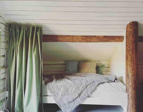 a bedroom with a bed with a wooden frame at Torpet Hagalund, Mariefred in Mariefred