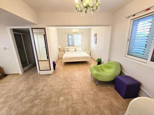 a large room with a bed and a mirror at Paphos Central Penthouse in Paphos City