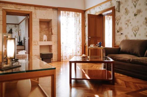 a living room with a couch and a table at Santa Rosa Relais in Noci