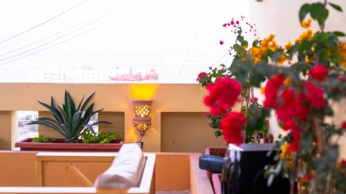 a room with flowers in vases on a table at Lazur Sea & City Apartment's - El Hadaba, Hurghada - Egypt in Hurghada