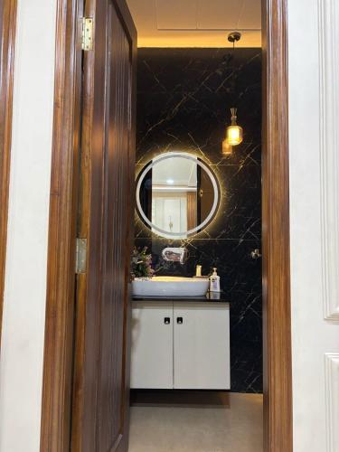 a bathroom with a sink and a mirror at DeeHa Niwas Luxe -Modern Luxury 1BHK in City Centre in Varanasi