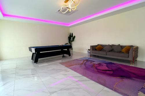 a living room with a couch and a piano at Grand Aeden Villa in Kuala Kangsar