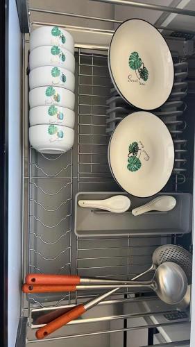a rack with plates and utensils in a refrigerator at Sandbank Dream in Fengdeng