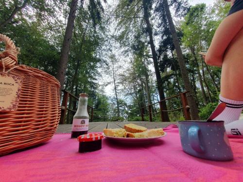 a table with a plate of bread and a bottle of beer at Glamping Zeleni raj Vače in Vače