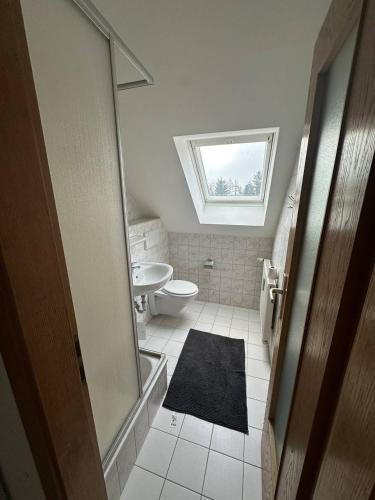 a bathroom with a toilet and a window at Monteurzimmer Iris&Jasmin in Hohenfelde