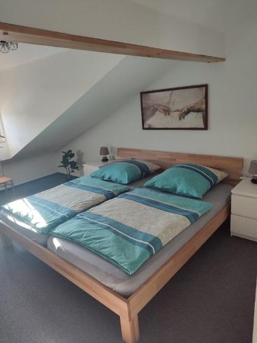 a large bed with blue pillows in a room at Ferienwohnung Schmidt in Bayerisch Eisenstein