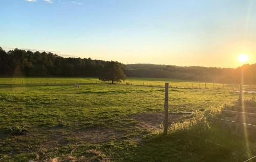 a fence in a field with the sun in the background at Nice Home In Saint-Géraud-De-Corps in Saint-Géraud-de-Corps
