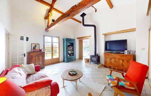a living room with a couch and a tv at Nice Home In Saint-Géraud-De-Corps in Saint-Géraud-de-Corps