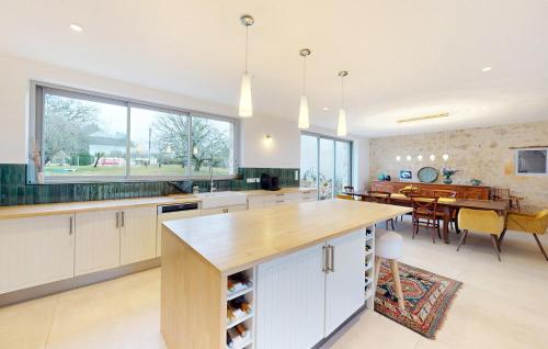 a kitchen with a table and a dining room at Nice Home In Saint-Géraud-De-Corps in Saint-Géraud-de-Corps
