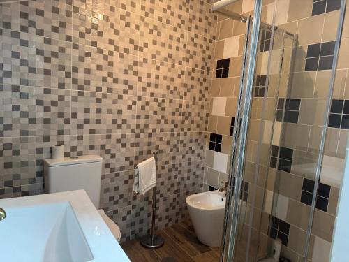 a bathroom with a toilet and a sink and a shower at Casa da Barragem in Negrões