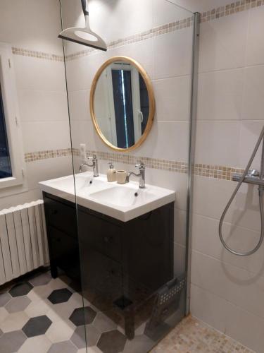 une salle de bain avec un lavabo et un miroir dans l'établissement Au coeur des vignes, à Grospierres
