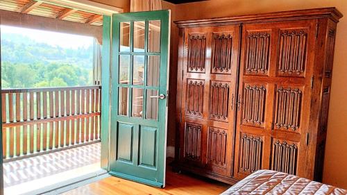 a room with a wooden door and a balcony at Quinta do Burgo - Nature Hotel in Amares