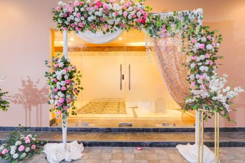 a wedding altar with pink and white flowers at Super Townhouse Viraj Khand Formerly Veridian Inn in Lucknow