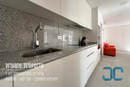 a kitchen with a sink and a counter top at Arada Property - 4 Houses in 1 Private Property, Free Parking and Hot Tub in Arada