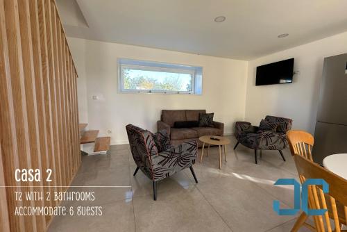 a living room with a couch and chairs at Arada Property - 4 Houses in 1 Private Property, Free Parking and Hot Tub in Arada