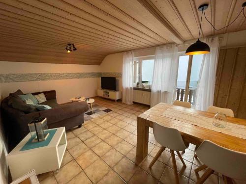 a living room with a couch and a table at Ferienwohnung Heilsberg in Gottmadingen