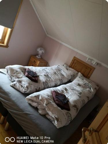 two beds with pillows on them in a bedroom at Ranchen in Sortland