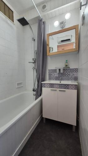une salle de bain avec un lavabo et une baignoire dans l'établissement Résidence Val Benoît face à la piste de ski l'aiguille en centre station 4 couchages, à La Foux d'Allos