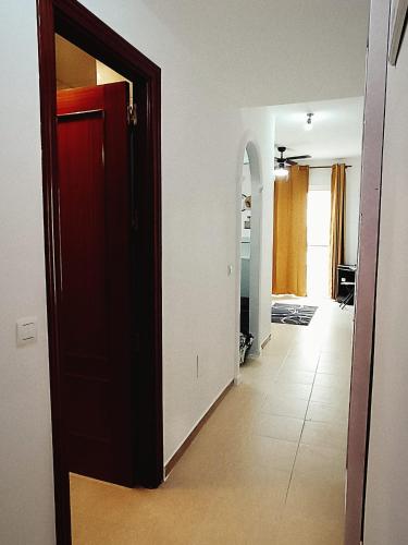 a room with a red door and a hallway at Capuchinos House Apartment in City Center in Málaga