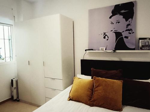 a bedroom with a bed with a black and white at Capuchinos House Apartment in City Center in Málaga