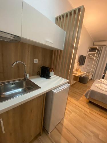 a kitchen with a sink and a counter top at Erietti Studios in Leptokarya