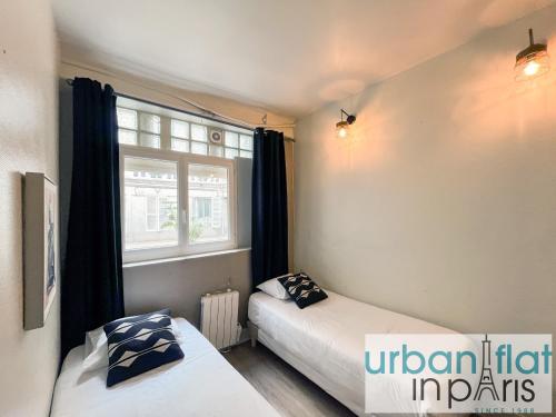 une chambre avec deux lits et une fenêtre dans l'établissement 06 - Richer, à Paris