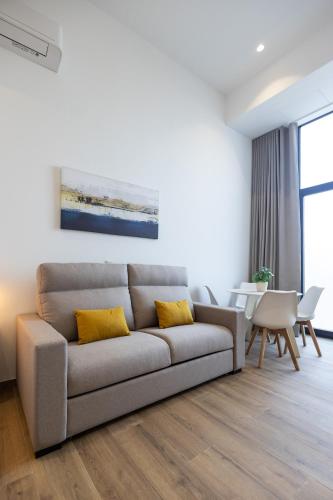 a living room with a couch and a table at Les Arts Plaza by Concept Flats in Valencia