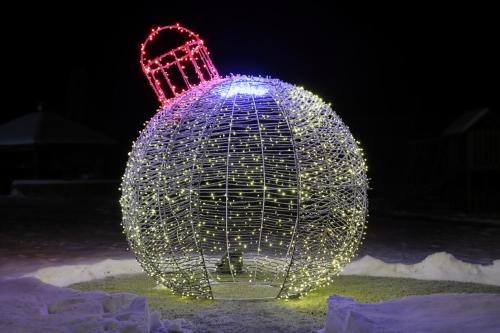 a light orb covered in lights in the snow at Villa Rose & SPA in Mežciems