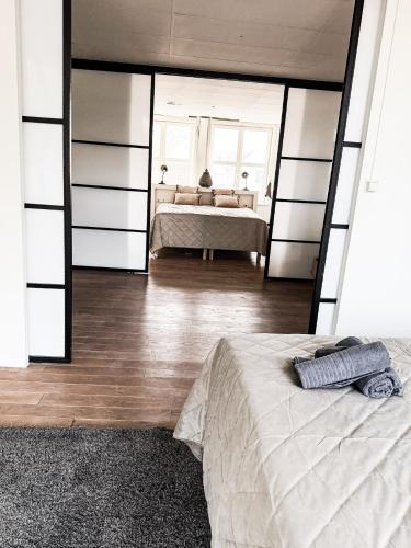 a bedroom with a bed and a large mirror at Saya Loft in Amersfoort