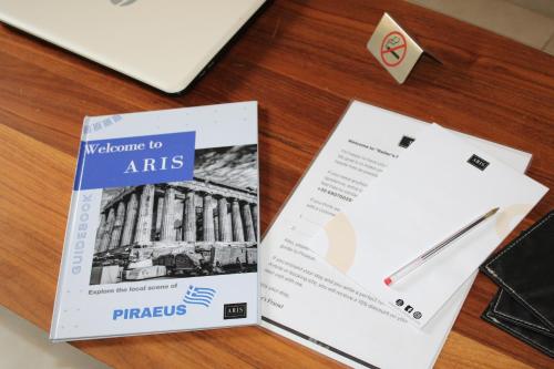 a table with a book and a pen and papers at ARIS Piraeus- Sailor's friend in Piraeus