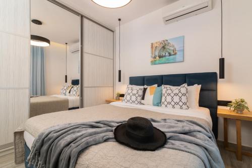 a bedroom with a bed with a hat on it at AKEA VILLAS in Tragaki