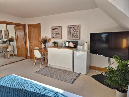 a living room with a large flat screen tv at Twin Pines in Mulben