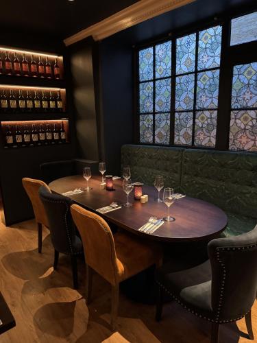 a table in a restaurant with wine glasses at The Ormond At Tetbury in Tetbury