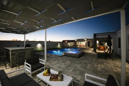 a backyard with a swimming pool and a house at Luxury Villa Blue Sky in Široki Brijeg