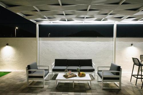 a living room with a couch and chairs and a table at Luxury Villa Blue Sky in Široki Brijeg