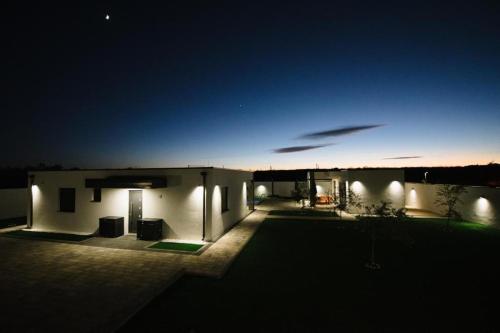 a view of a house at night with lights at Luxury Villa Blue Sky in Široki Brijeg