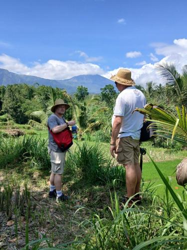 a man and a woman standing in a field at Green Escape in Tetebatu