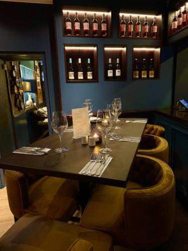 a table in a restaurant with wine glasses at The Ormond At Tetbury in Tetbury