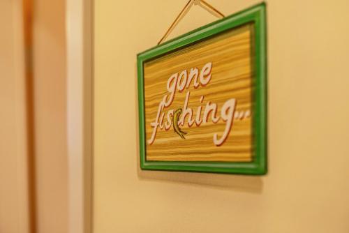 a sign on a wall that saysgone laughing at SCHUSTERjunge Aparthotel in Sasbachwalden
