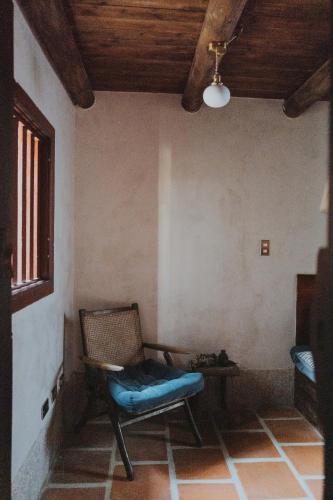 a room with a chair and a table and a window at 島中大厝 in Jinhu